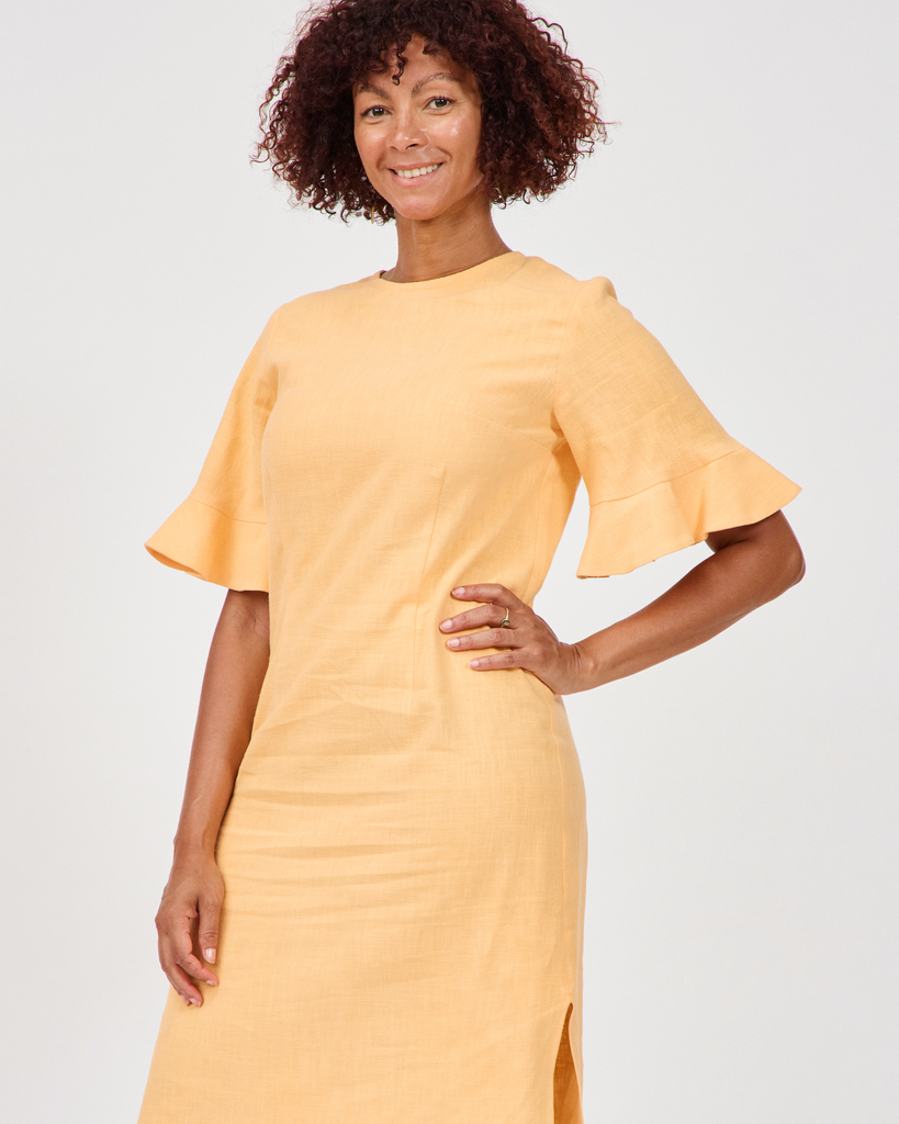 Model wears Billy Linen Dress in butterscotch