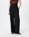 model wearing black pleated pants 