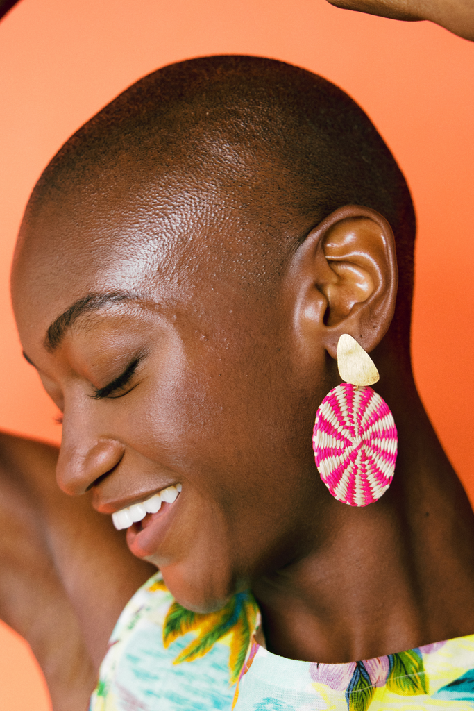 Model wears Casa Bonita Iraca Palm Statement Earrings - Pink/ Natural