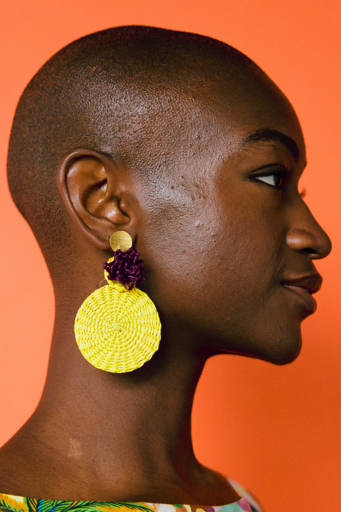 Model wears Casa Bonita Iraca Palm Yellow Flower Earrings