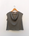 Checked Cowl Draped Top hanging against white wall.