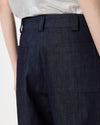 model wearing denim barrel leg pants, up close image of waistband and back pockets