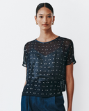 Model wears Navy Dolman top with silver speckles throughout the fabric