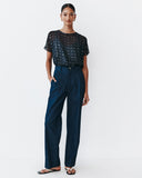 Model wears Navy Dolman top with silver speckles throughout the fabric