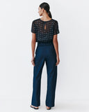 Model wears Navy Dolman top with silver speckles throughout the fabric