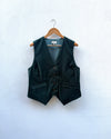 Dark green vest on a wooden hanger against a white background