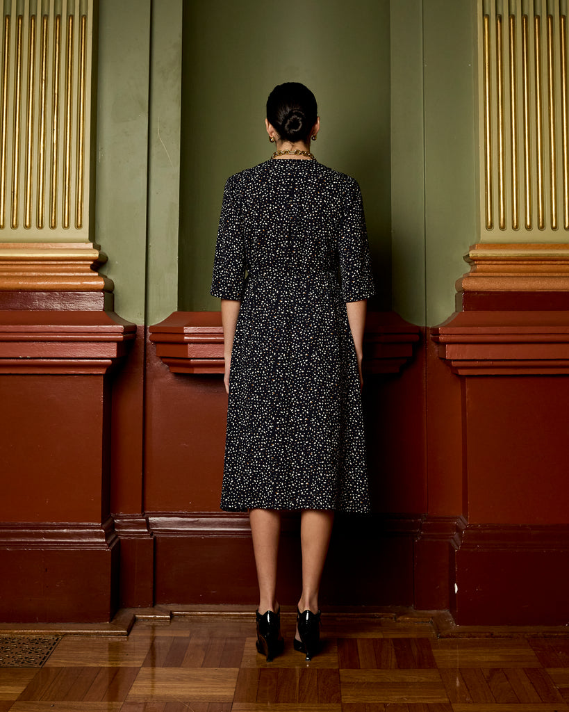 Model wears Navy Spot Wrap Dress