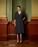 Model wears Navy Spot Wrap Dress