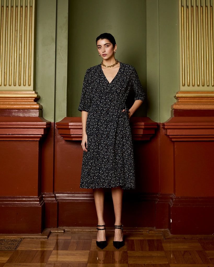 Model wears Navy Spot Wrap Dress