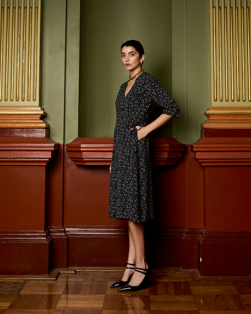 Model wears Navy Spot Wrap Dress