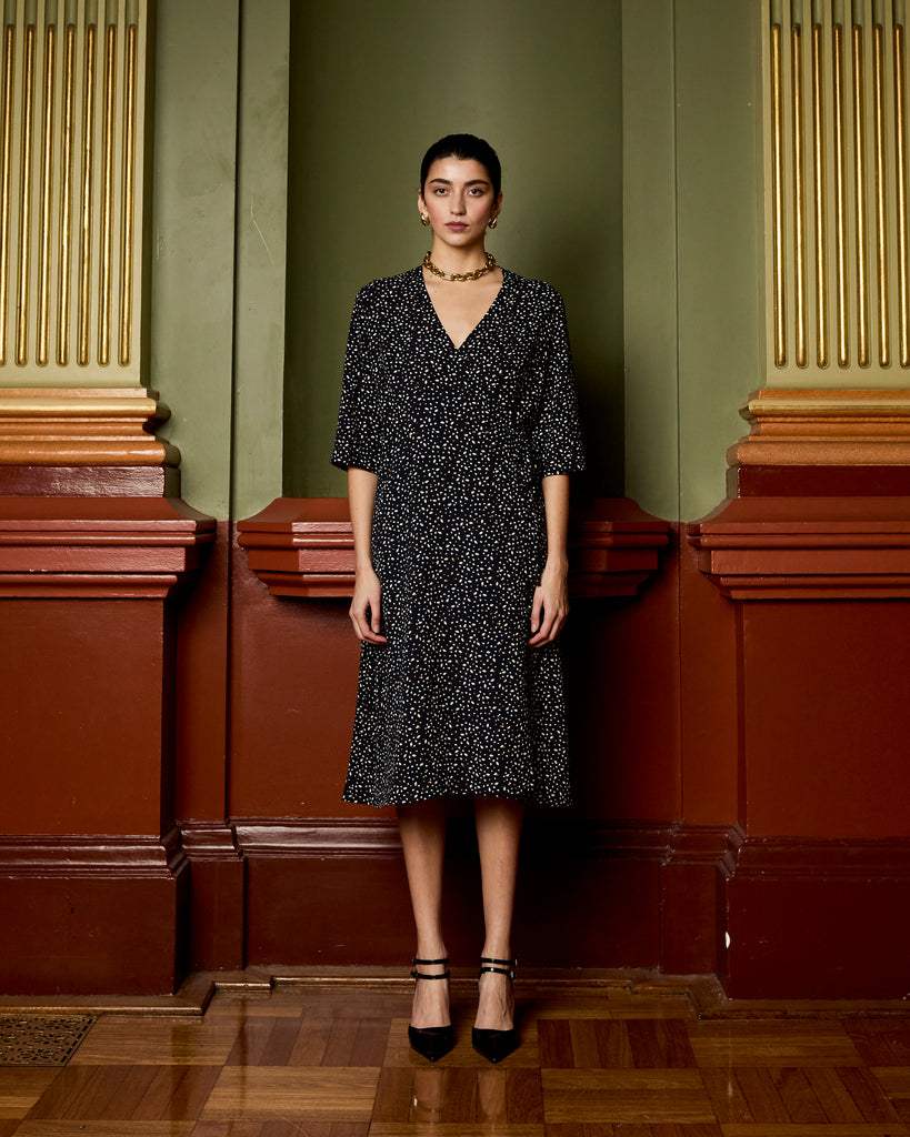 Model wears Navy Spot Wrap Dress