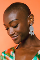 Model wears Quazi Design Grey Lifu Layered Earrings