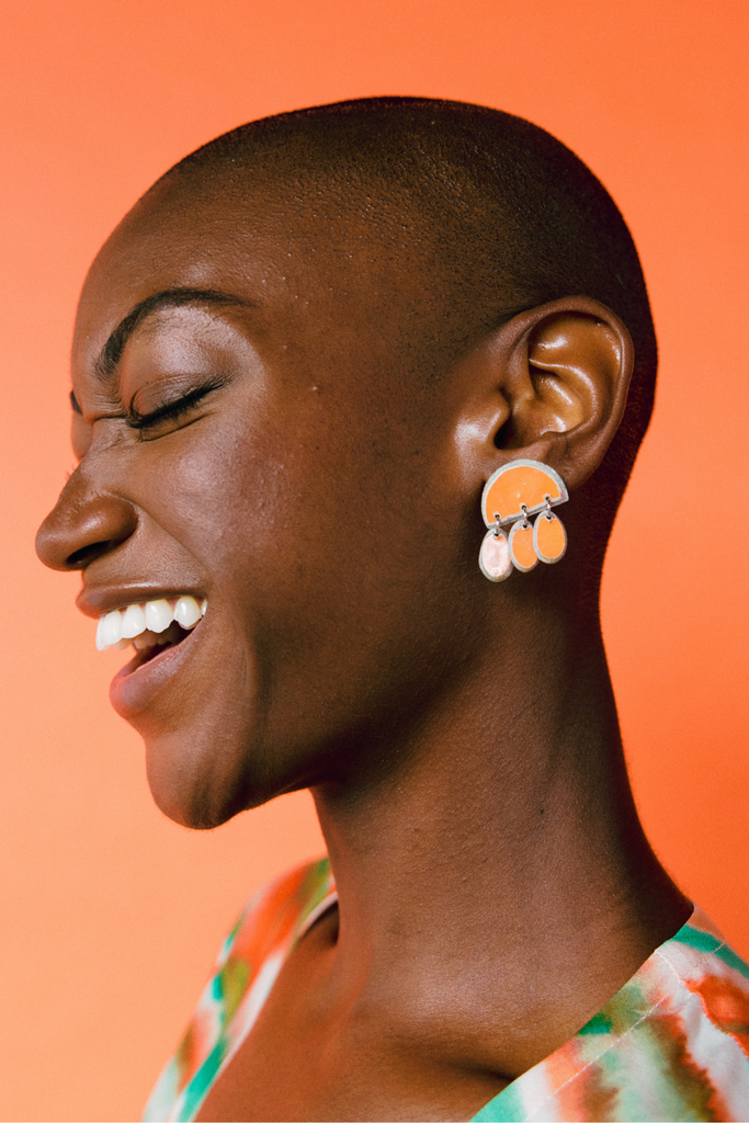 Model wears Quazi Design Orange Litulu Earrings