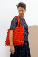 Model wears Ha Leh Tote Red