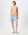 model wearing pale blue elemental denim shorts, and nectar cami top