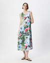 A woman modeling a sleeveless midi dress with a vibrant multicolor floral print on a light background, paired with black flip-flop sandals, against a plain white studio background.