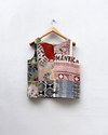 Patchwork-style tank top on a hanger against a white background