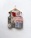 Patchwork-style tank top on a hanger against a white background