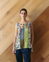 Model wears Singlet Top - Mixed Prints against wooden background