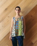 Model wears Singlet Top - Mixed Prints against wooden background