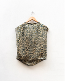 Leopard print top on a hanger against a white background