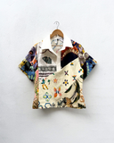 Colorful patterned shirt on a hanger against a white background