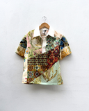 Colorful patterned shirt on a hanger against a white background