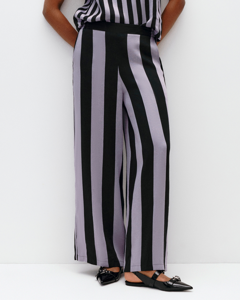 Model wears wide leg pants in Lilac Stripe