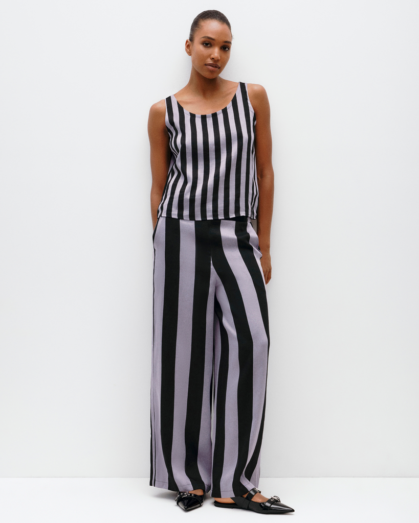 Model wears wide leg pant in lilac stripe