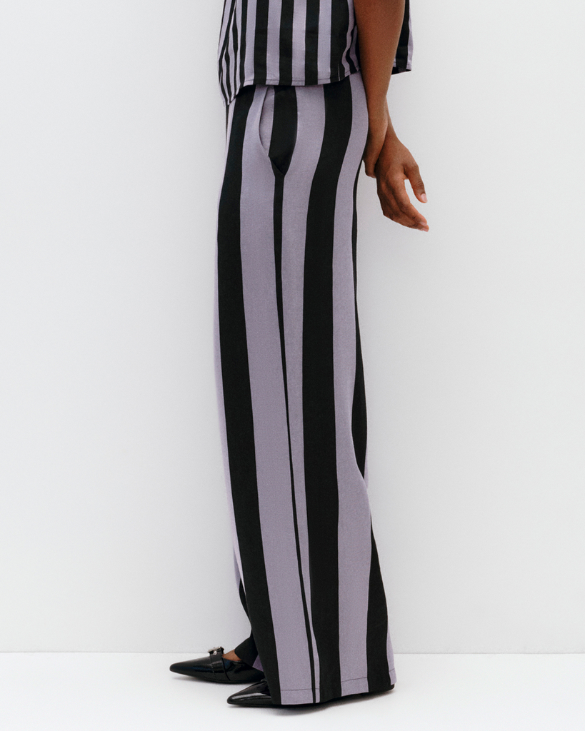 Model wears wide leg pant in lilac stripe