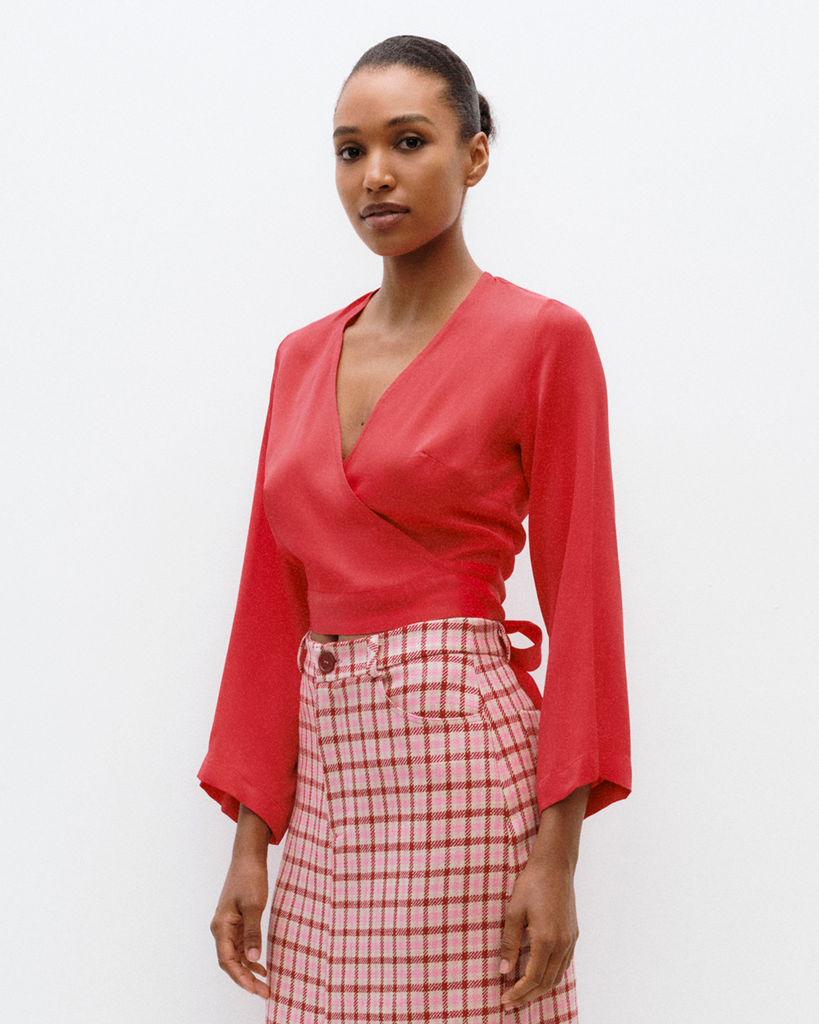 Model wears wrap top in flame