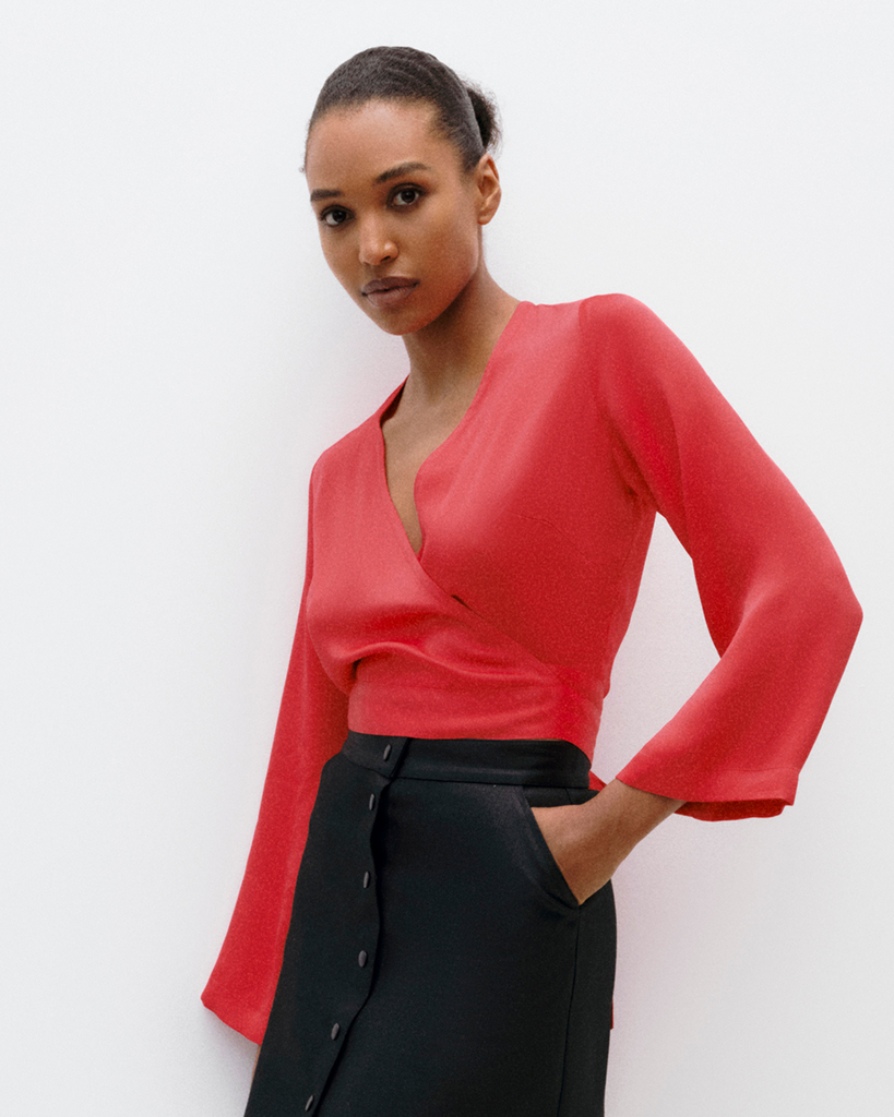 Model wears wrap top in flame