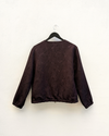 Burgundy jacket on a hanger against a white background