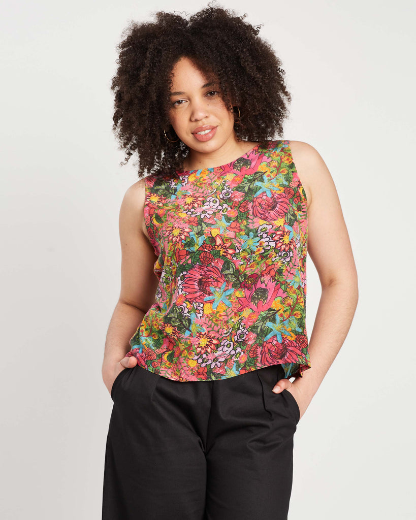 woman wearing multi colour silk shell top camisole with print on top of black wide leg denim culottes