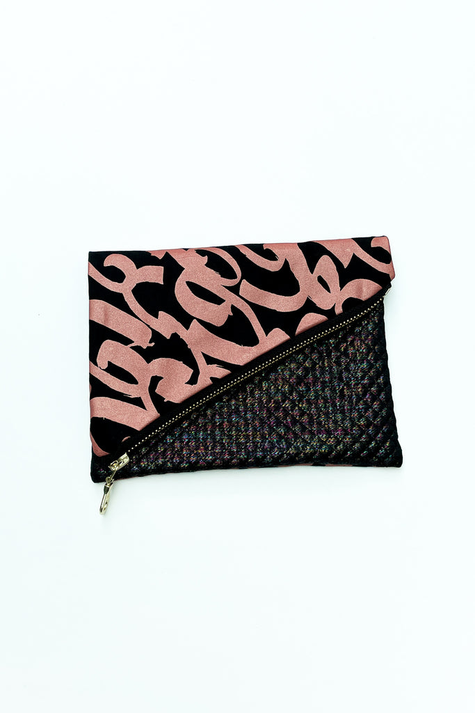 printed foldover purse with zip against white backdrop