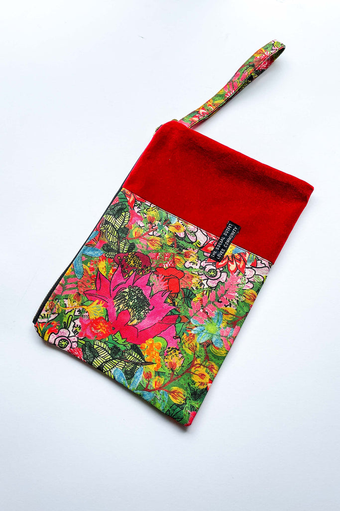 colourful fairfield bloom spliced clutch purse with red contrast fabric on white background
