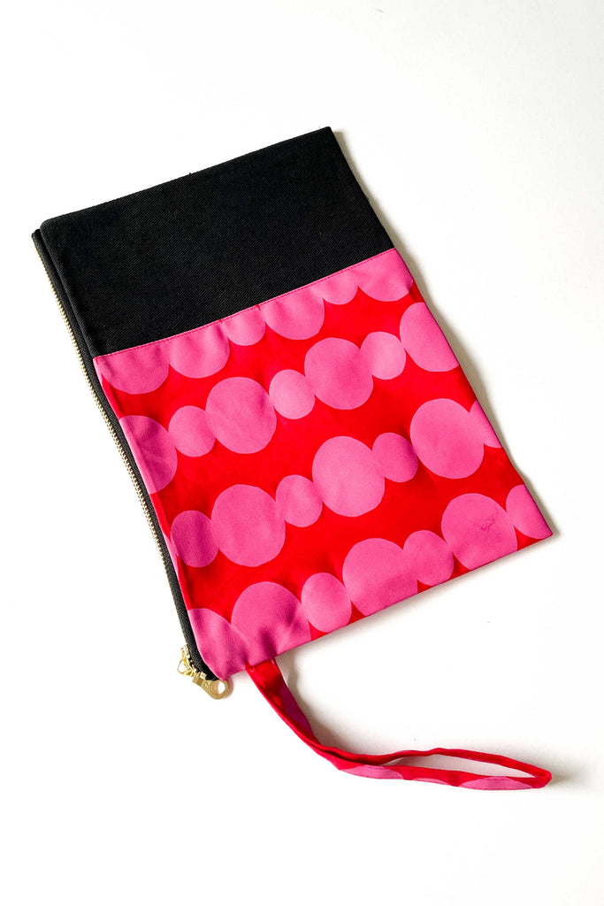 friendship beads spliced clutch with black contrast denim fabric against a white backdrop