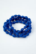 sapphire single strand necklace sitting against a white backdrop