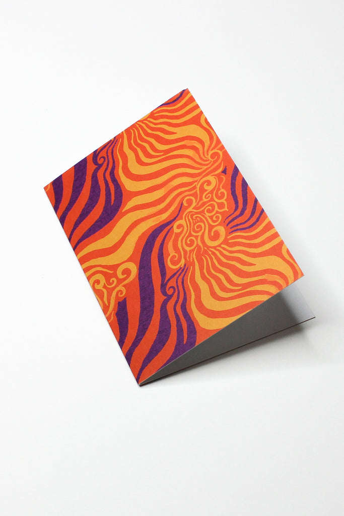 orange and purple printed greeting card on top of white background