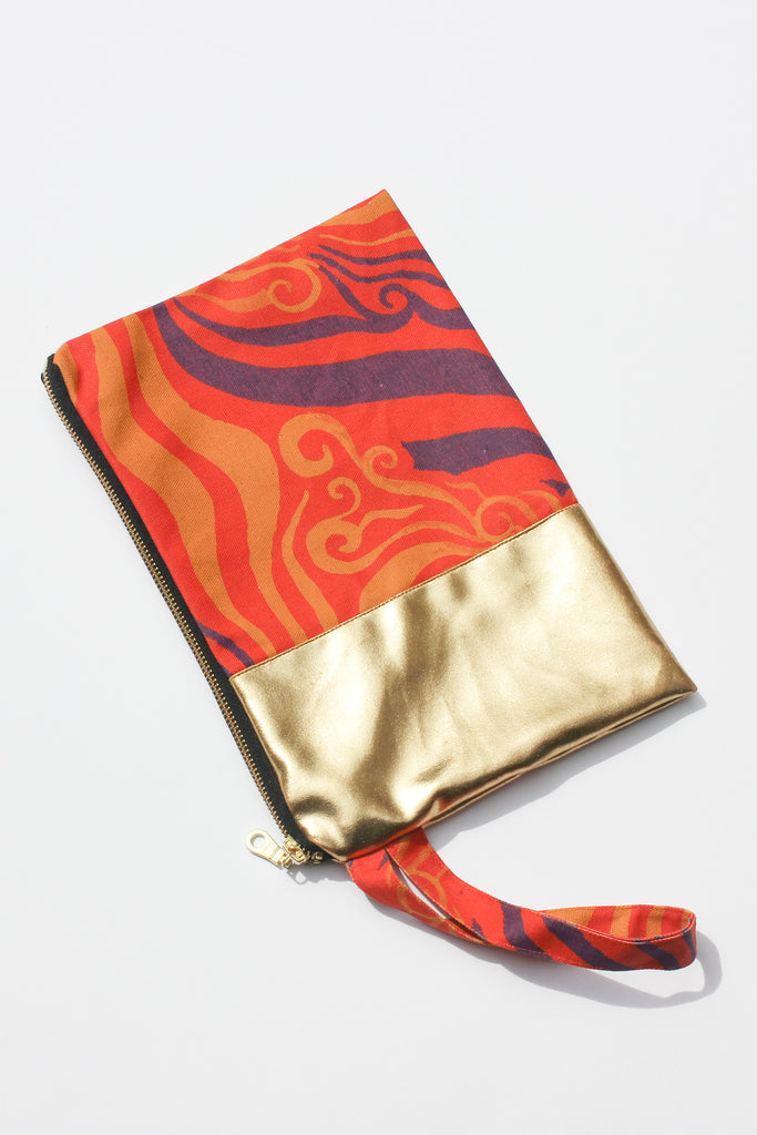orange and purple printed organic canvas clutch spliced with remnant gold fabric and strap
